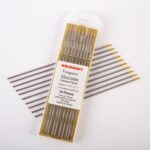 Close-up of a 10-pack of Weldcraft 2.4mm (3/32 inch) gold pure tungsten electrodes for TIG welding, ground finish, on a gold background.