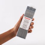 Hand holding of ten Weldcraft 3.2mm (1/8 inch) gray 2% ceriated tungsten electrodes for TIG welding, ground finish.