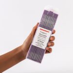Hand holding of 2.4mm (3/32 inch) purple pure tungsten electrodes (WT30) for TIG welding, ground finish